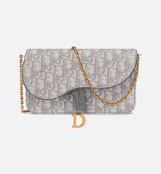 The Saddle pouch with chain is a modern and practical creation with smooth and harmonious lines. Crafted in gray Dior Oblique jacquard, it features an asymmetric flap and an antique gold-finish metal D stirrup. The spacious interior will accommodate any essentials, while the chain allows it to be worn over the shoulder or crossbody. The medium pouch can be ideally paired with other Saddle creations.. Gris Dior, Saddle Pouch, Dior Purse, Luxury Outfit, Dior Collection, Dior Oblique, Girly Bags, Christian Dior Couture, Dior Couture