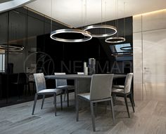 a modern dining room with black walls and wooden flooring, round chandelier above the table