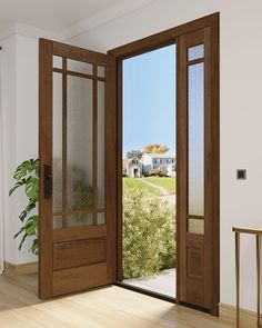 an open wooden door in a white room with wood flooring and large glass doors