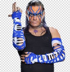 the wrestler is wearing blue and white paint on his face, while he holds his arm up