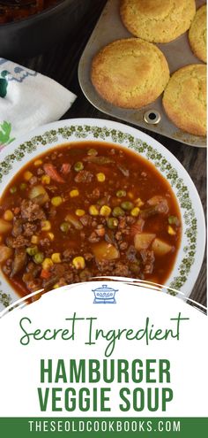 a bowl of hamburger veggie soup next to muffins on a plate