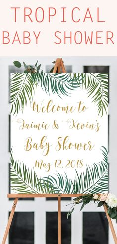 a tropical baby shower sign with flowers and greenery on it, next to an easel