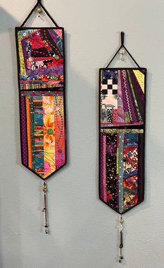 two wall hangings made out of colorful fabrics