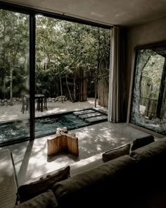 a living room filled with furniture next to a large sliding glass door that looks out onto a pool