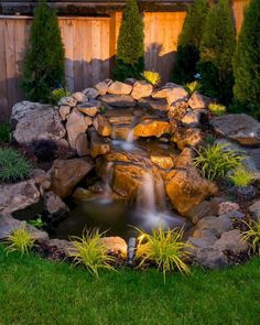 a small waterfall in the middle of a garden