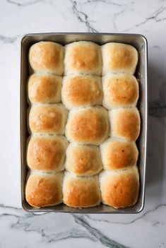 rolls in a pan on a marble counter top