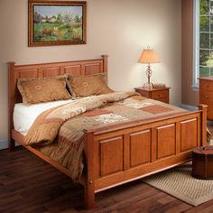 a bed room with a neatly made bed and two night stands next to a window