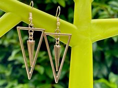 Oh these are the bomb!  So retro and cool and absolutely bang on trend.   Spike triangle earrings in two colours.  Oh my!  I've used triangle connectors and spike charms in silver and champagne gold.  I've paired them with gold ear wires in the same shade. The triangles are 4.5 cm and the whole earring is a lovely 6 cm in total including the ear wire. Just choose colour at checkout.   Spiky! All items come in a beautiful pink organza bag and/or white tissue paper.  Perfect for gift giving.  Plea Trendy Gold Triangle Earrings, Trendy Triangle Earrings, Retro Geometric, Triangle Earrings, Champagne Gold, Geometric Art, Ear Wire, Earrings Gold, Ear Wires