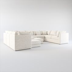 a white couch and ottoman in an empty room