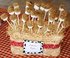 a basket filled with marshmallows on top of a red and white checkered table cloth