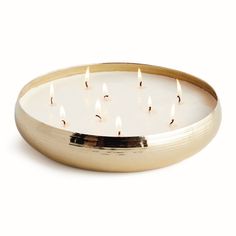 a brass plate with five lit candles in it