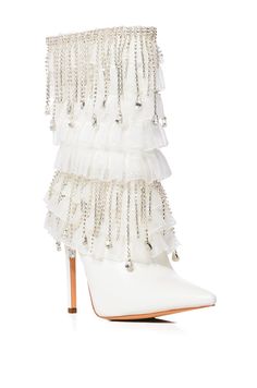 The AZALEA WANG Lexley White Diamond Drop Boot features a faux leather upper, a tiered ruffle design, cascading rhinestone link fringe, a pointed toe silhouette, a mid-calf height shaft, a slim stiletto heel, and a slip-on fit.  (all measurements approximate from size 7.5):  - Textile Upper - Pointed Square Toe - 7.65” Shaft Height - 4.5” Heel Height - 14” Calf Circumference - Imported  Product ID: 354504 Azalea Wang, Ruffle Design, Diamond Drops, Stiletto Heel, White Diamond, Mid Calf, Stiletto Heels, Heel Height, Leather Upper