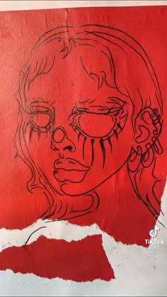 a drawing of a woman's face on red paper