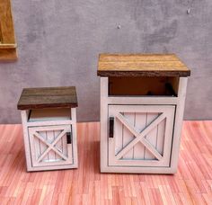 two small wooden boxes sitting on top of a hard wood floor next to each other