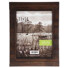 an old wooden frame with a farm scene in the background and a green sticker that says 11x4