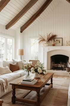 a living room filled with furniture and a fire place in the middle of a room