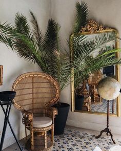 there is a chair and mirror in the room with palm trees on the wall next to it