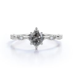 a white gold engagement ring with a pear shaped diamond