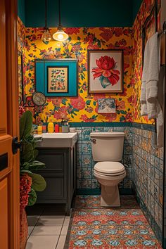 a bathroom with colorful wallpaper and tile flooring