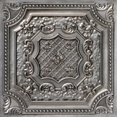 a square metal ceiling tile with an intricate design