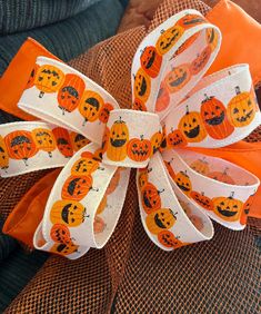 an orange and white ribbon with pumpkins on it