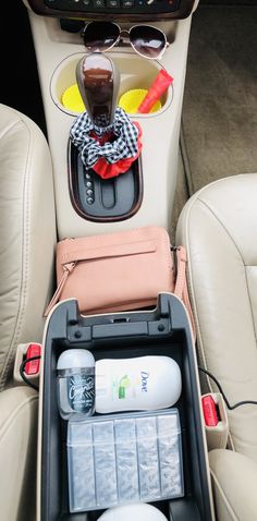 the inside of a car with sunglasses and other items in its back seat compartment,