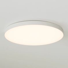 a white ceiling light that is on the wall