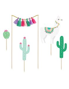 llamas, cactuses and tassels are on sticks in front of a white background