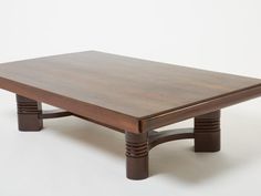 a wooden coffee table sitting on top of a white floor