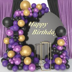 a happy birthday sign surrounded by balloons in front of purple and black drapes