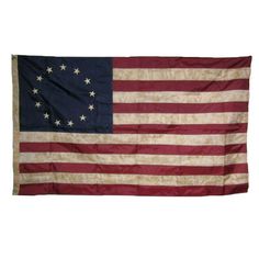 an old american flag hanging on a wall