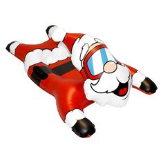 an inflatable santa claus is flying through the air