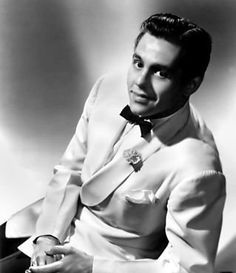 a black and white photo of a man in a tuxedo