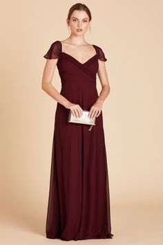 a woman in a long burgundy dress