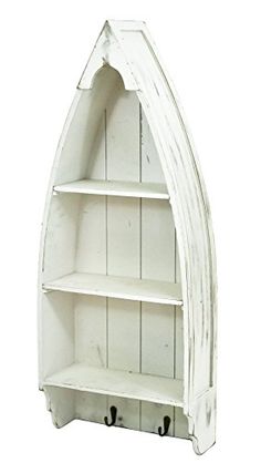 a white boat shaped shelf with three shelves