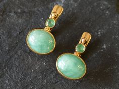 Gold Emerald Earrings set with Natural Emeralds in a natural green color at sizes 10x8mm & 3mm, from Colombia.Gold Vermeil: 18k Gold over Solid 925 Sterling Silver ☞ made to last.Matching Ring & Pendant☞ please ask meDetails:• Natural Emerald sourced from Colombia• Emerald: 10x8mm each, 6 Ct a pair, cabochon cut• Small Emerald: 3mm each, 0.2 Ct a pair, diamond cut• Lever Back Closure - "English Lock"• Dimensions: Length 15mm, Width 10mm• 18k Gold Vermeil❀ Each Natural Gem is unique & will have S Elegant Green Oval Clip-on Earrings, Gold Emerald Earrings, Matching Ring, Birthstone Earrings, May Birthstone, Ring Pendant, Birthstone Earring, Emerald Earrings, Matching Rings