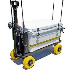 a large white cooler sitting on top of a yellow wheelbarrow with two handles