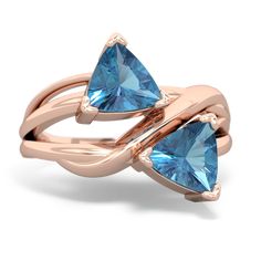 two triangular shaped blue topazte rings with rose gold accents