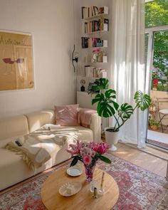 a living room filled with furniture and a large window