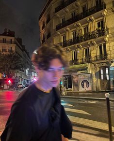 a man walking down the street at night