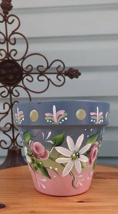 a flower pot sitting on top of a wooden table