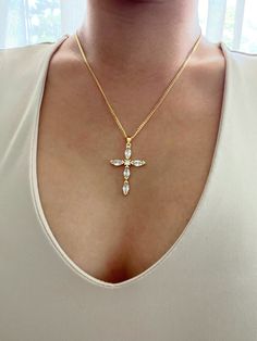 This cubic zirconia cross truly looks like real diamonds and sparkles beautifully. Picture and video does not emit how sparkly this cross looks. Cross is hung from a modern and casual chain for the perfect every day design! Necklace comes in a more casual 18k gold plated chain or a daintier 14k gold filled chain for a more elegant look. It is of great importance to me that I make jewelry for my customers that I, myself, wear every day. Each jewelry piece is handmade by me personally with love an Diamond White Cross Pendant Necklace In Cubic Zirconia, Diamond White Cubic Zirconia Cross Pendant Necklace, Diamond White Cubic Zirconia Crucifix Necklace, Gold Rhinestone Cross Pendant Necklace, Gold Crystal Rhinestone Cross Pendant Necklace, Diamond White Crucifix Necklace As Gift, Clear Cubic Zirconia Cross Pendant Necklace, Diamond White Cross Necklace, Diamond White Crystal Cross Pendant Necklace