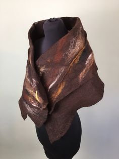 This beautiful soft hand felted wool Stole is Made from fine quality merino wool. Using the wet felting technique the wool is felted onto fine cotton Musiln , and is blended with autumnal colours and natural fibres such as flax , silk , and hemp fibres. THIS BEAUTIFUL STOLE IS ON OFFER AS PART OF MY SPRING CLEANSE CAMPAIGN. AS I HAVE HAD ALL MY SHOW , EXHIBITIONS ,MARKETS AND FESTIVALS CANCELLED FOR THSI YEAR SO FAR , AND ALL THE SHOPS ARE CLOSED ,I HAVE DECIDED TO DO A SPRING CLEAN OF MY STUDIO Handmade Brown Shawl For Fall, Brown Wool Shawl One Size, One Size Brown Wool Shawl, Brown One-size Wool Shawl, Brown Wool Shawl, Spring Cleanse, Winter Shawl, Types Of Cakes, Boho Accessories