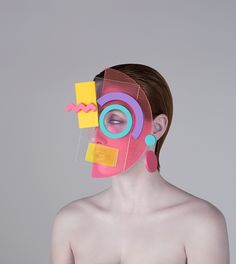 a woman's face is made up of different colored pieces of paper and plastic