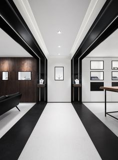 a black and white room with pictures on the wall