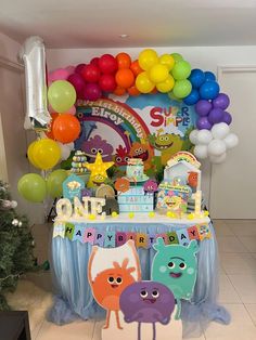 a birthday party with balloons, cake and decorations