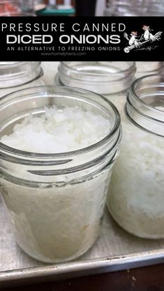 four jars filled with white rice sitting on top of a metal tray next to each other