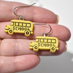 This listing is for one pair of lightweight school bus earrings.  Charm: (Measurement is from top of earwire to bottom of charm. The measurement may change slightly if you upgrade earwires.) * Plastic * School Bus - 27 mm long x 25 mm wide  Earwires: * The earwires are stainless steel and come with a clear back.  * I offer silver plated clip-on earrings and sterling silver hooks as well. Made from repurposed materials. Clear glue shows on the back. If you have any questions please send me a mess School Earrings, Bus Driver Appreciation, Teacher Earrings, Clear Back, Clear Glue, School Jewelry, Bus Driver, Fun Earrings, School Bus