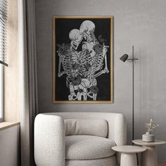 a living room with a white chair and a skeleton painting on the wall above it