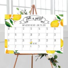 a calendar with lemons and flowers on it is displayed in front of a easel